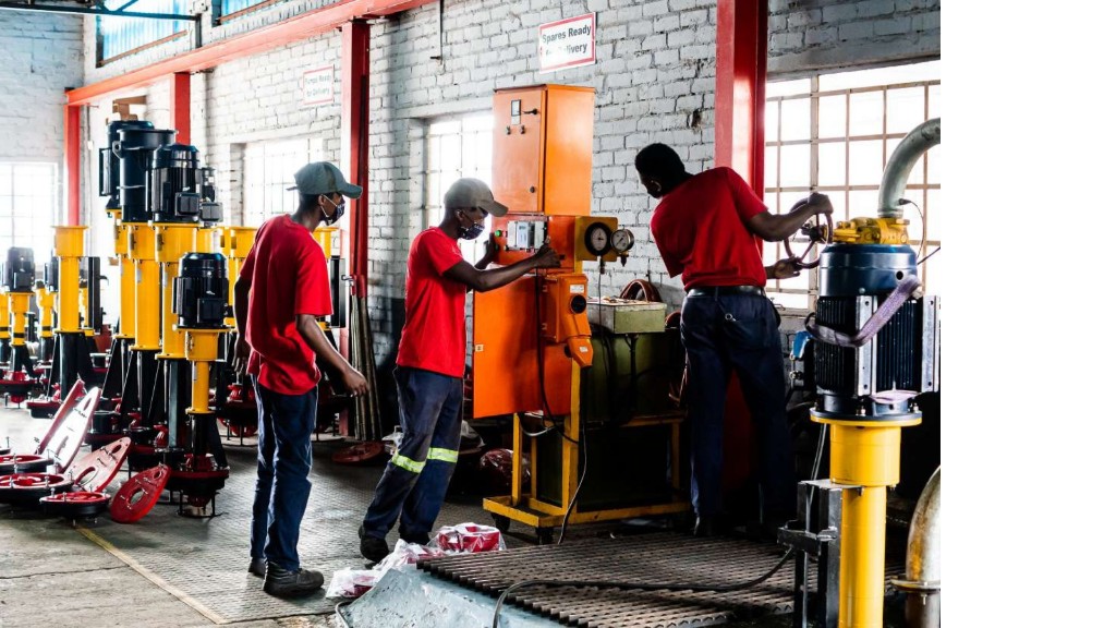 Titan Pumps workshop: technicians with pumps and spares ready for delivery
