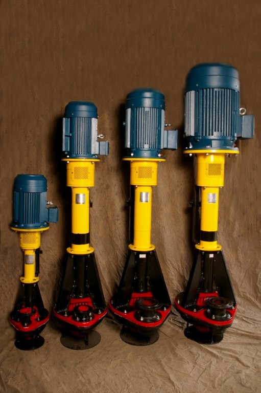 Four Titan vertical spindle pumps lined up from smallest to largest, with motors, yellow column shafts, and black pump bases